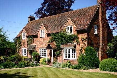 Brick village cottage with climbing plants